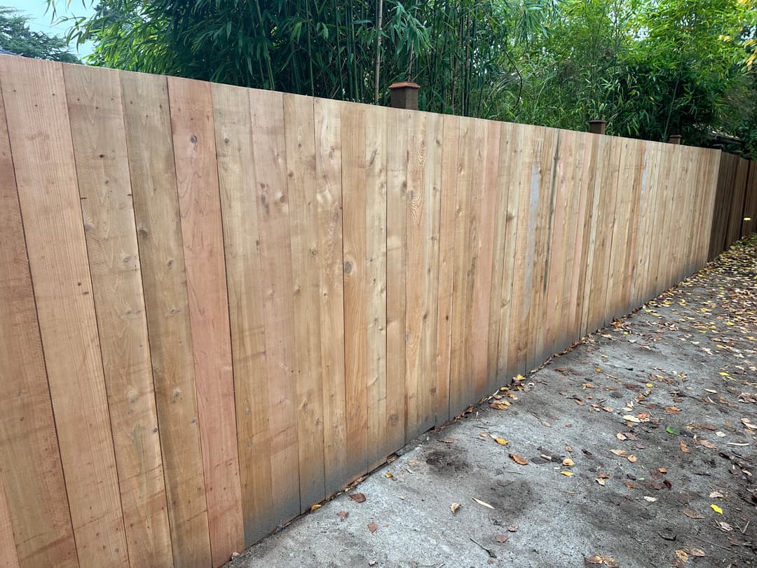 newly installed tall wooden security fence